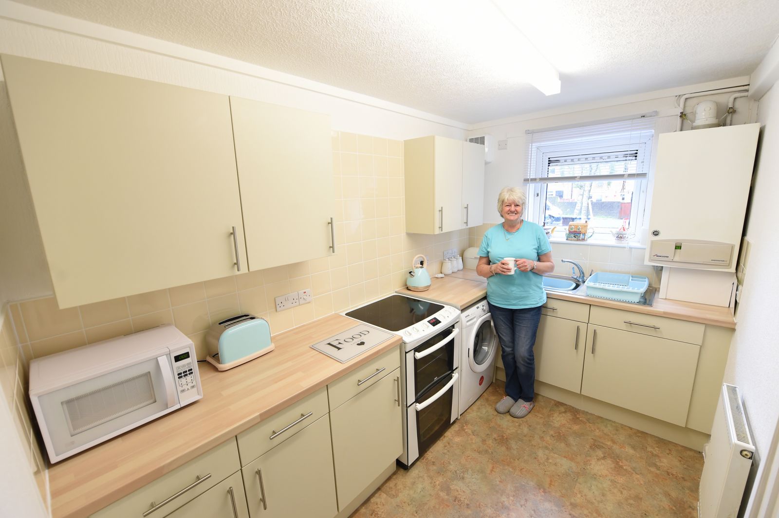 A tenant  in a brand new kitchen installed as part of Six Town Housing's capital works programme