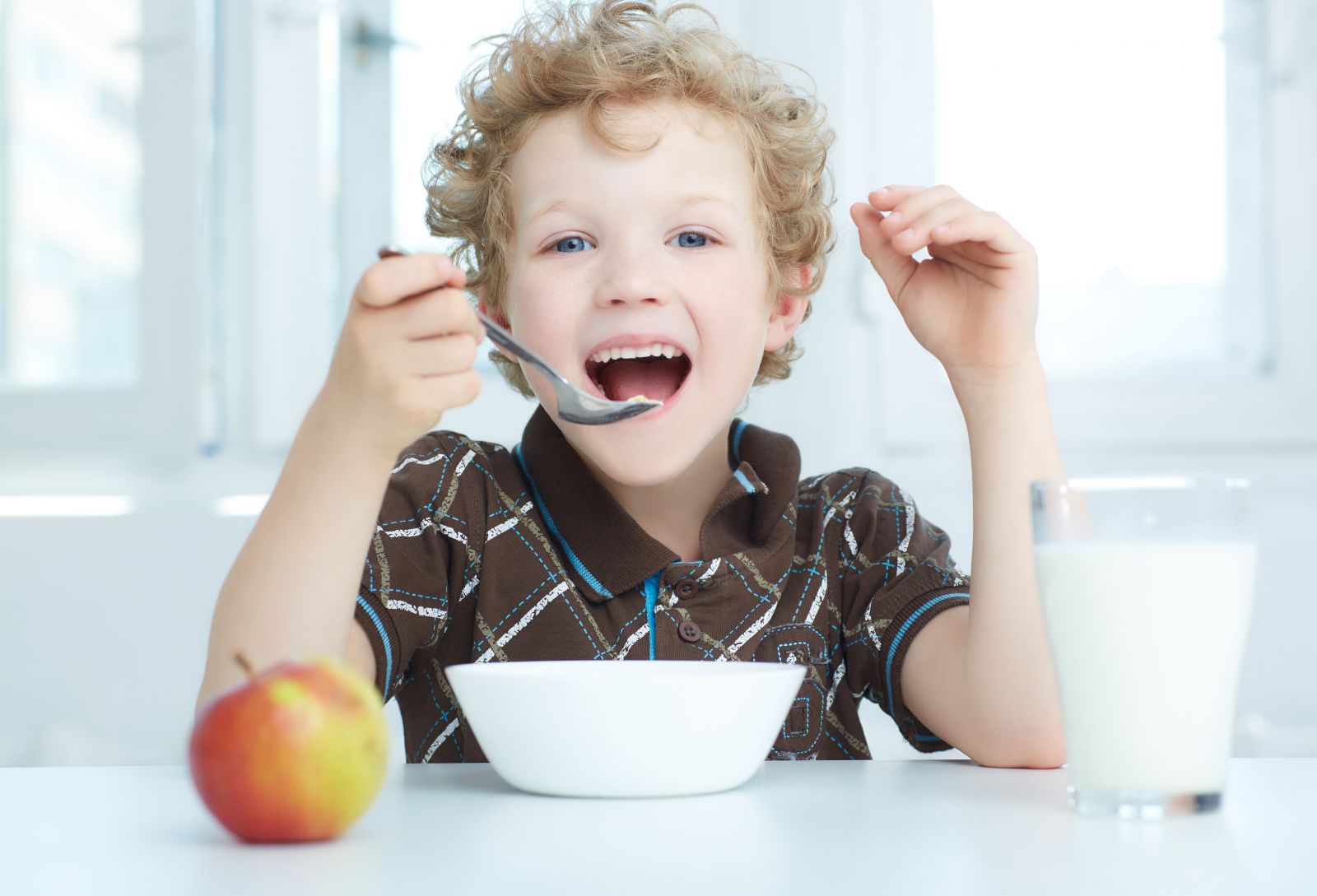 A young boy enjoying breakfast