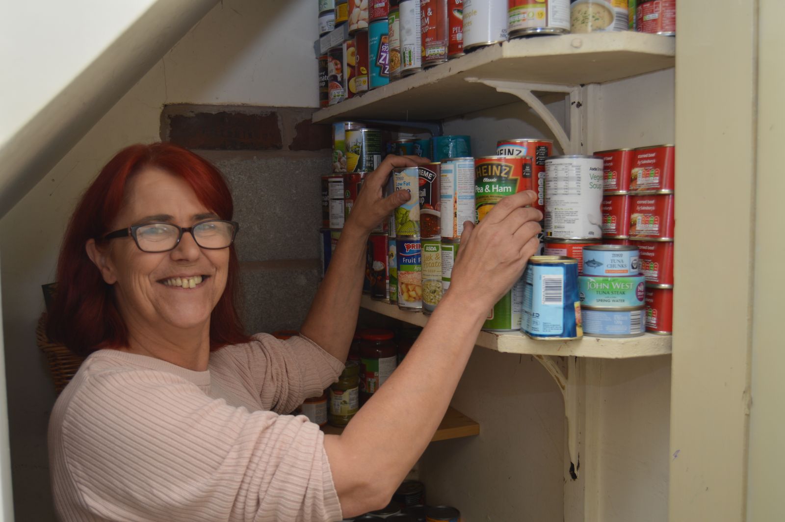 Cath stocking up the food bank store room.