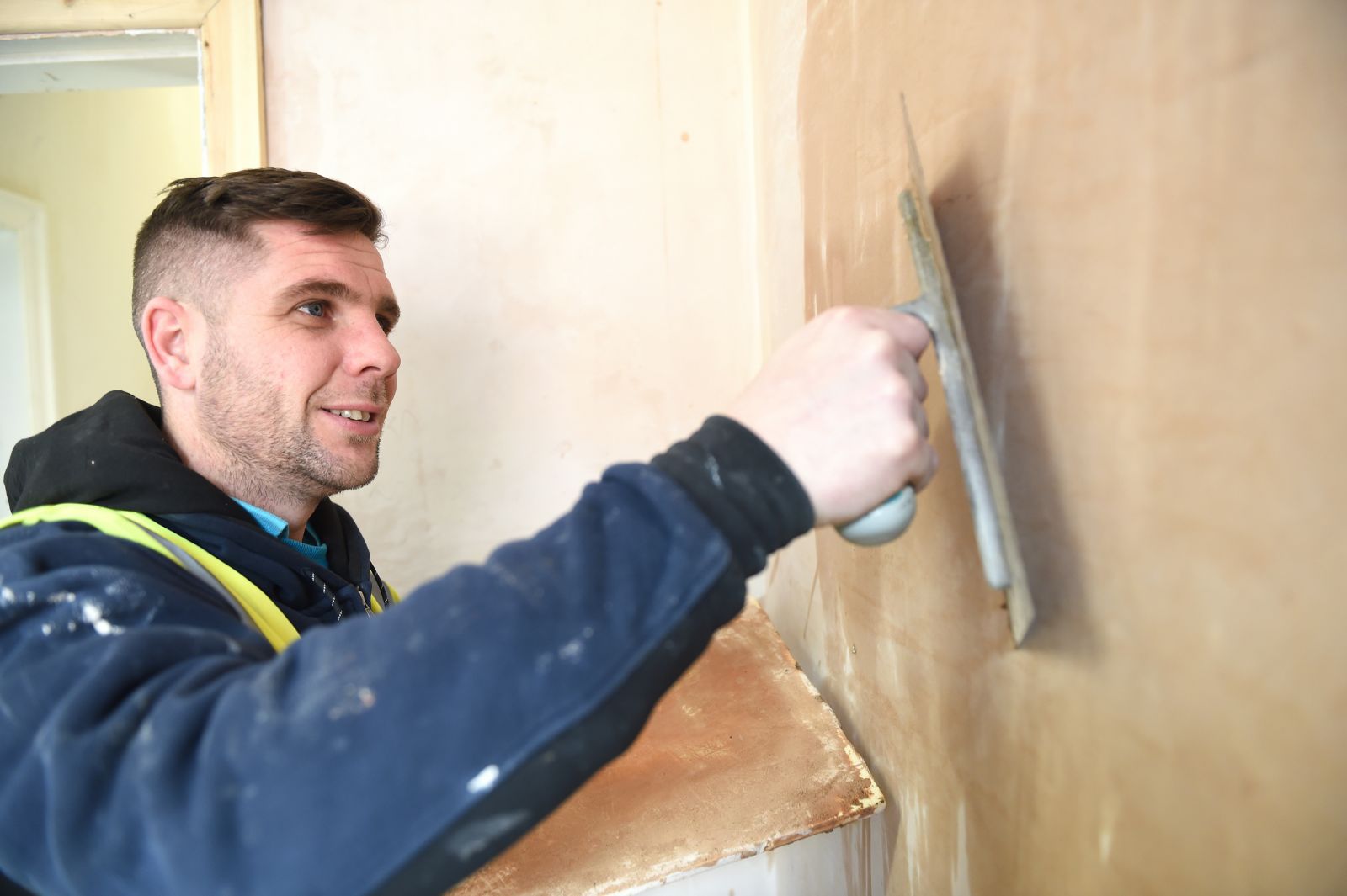Repairs Direct staff member plastering a wall